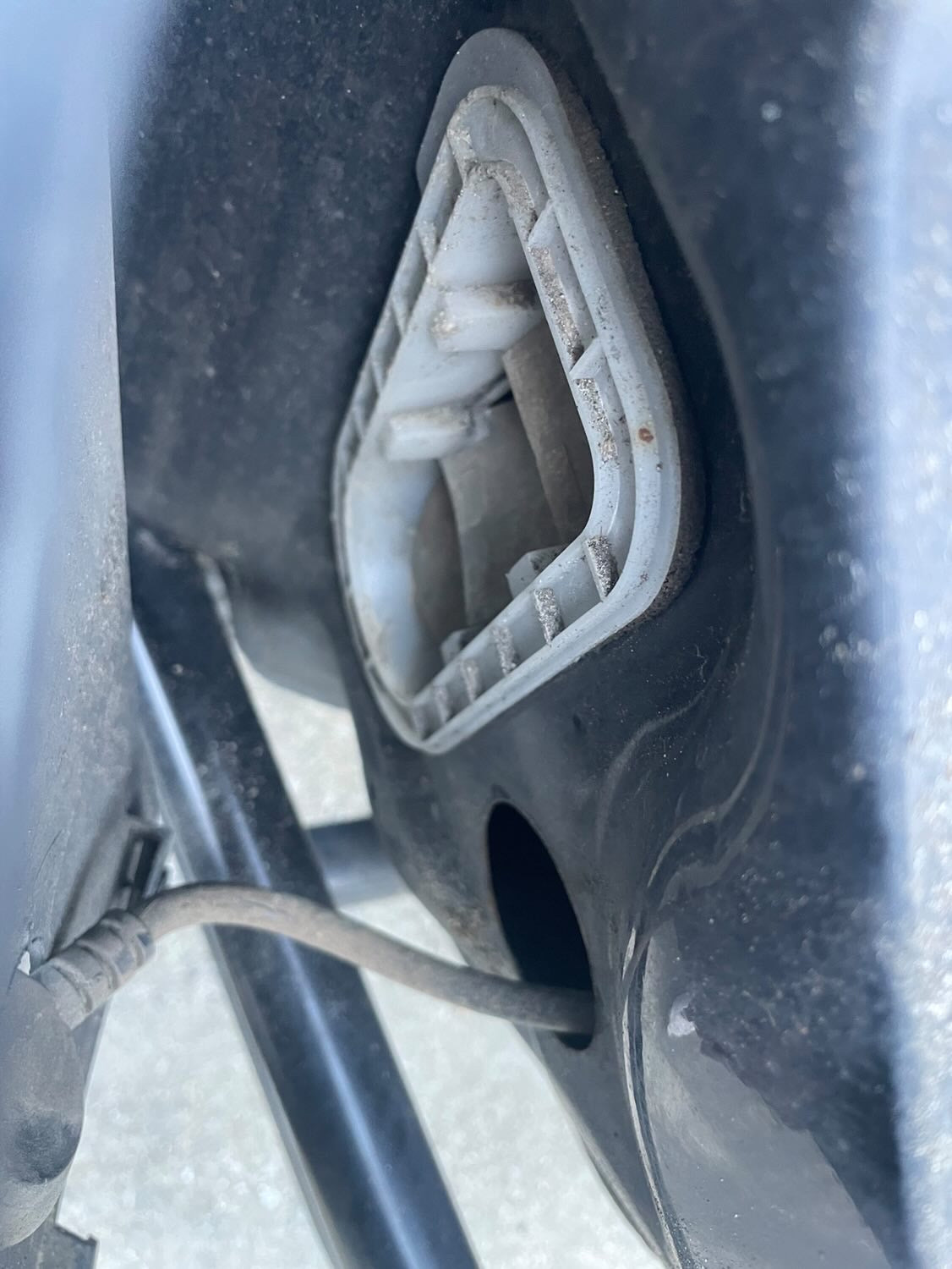 OEM vent located behind bumper, notice the rubber flaps. they are the main access point of dust, dirt debris, and even mice. It opens right into the cabin and collects behind interior panels  and pollutes the cabin.  